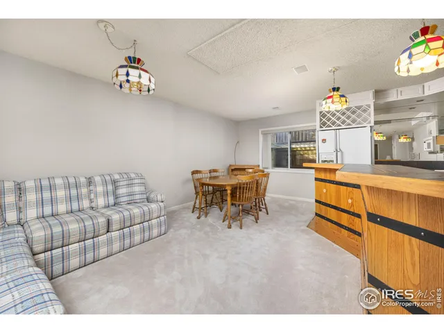 a living room with furniture and a kitchen view