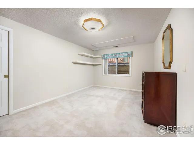 a view of a livingroom with wooden floor and window