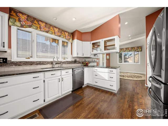 a kitchen with stainless steel appliances granite countertop a stove and cabinets
