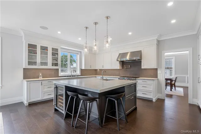 a kitchen with a table chairs sink and cabinets