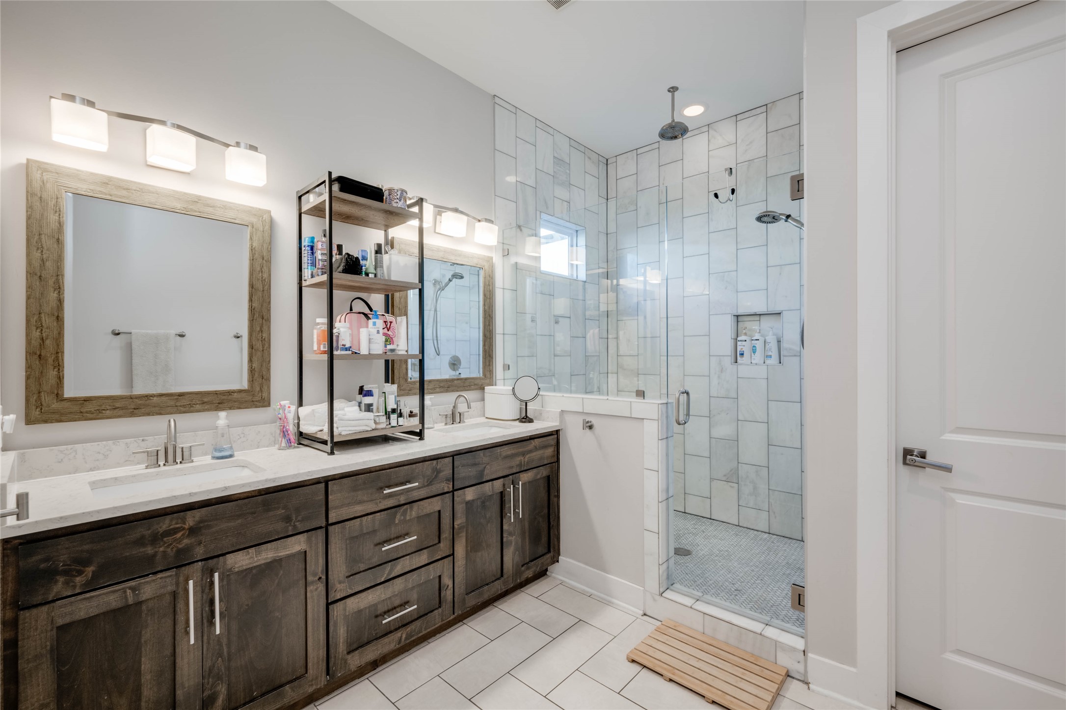 7514 Hardy Drive Austin, TX 78757 - Photo 20 of 29 Bathroom with double vanity, a stall shower, and light tile patterned flooring