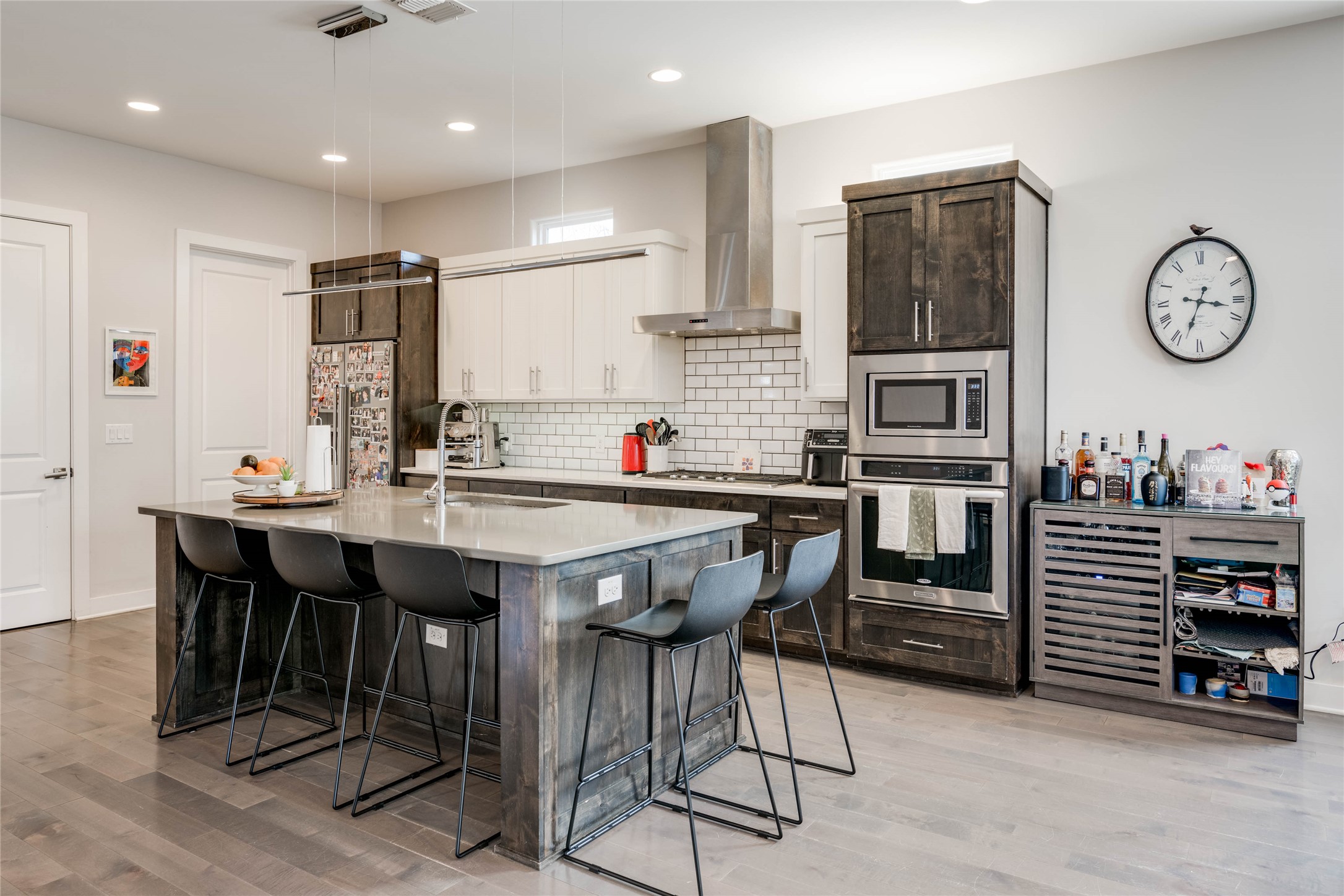 7514 Hardy Drive Austin, TX 78757 - Photo 7 of 29 Kitchen featuring dual tone cabinetry, a kitchen breakfast bar, stainless steel appliances, beverage cooler, and a kitchen island with sink