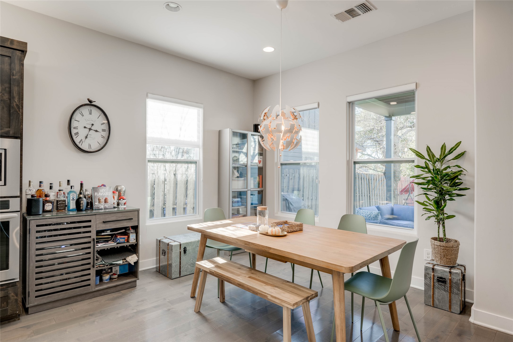 7514 Hardy Drive Austin, TX 78757 - Photo 10 of 29 Dining space featuring wood finished floors, suspended lighting, and healthy amount of natural light