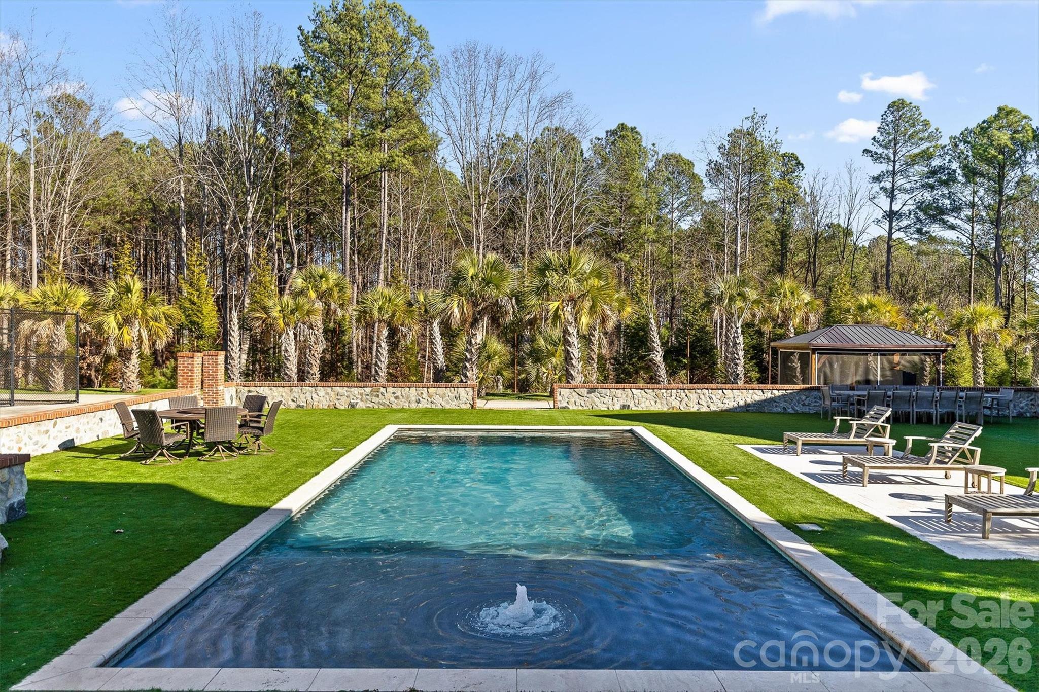 135 Stillwater Road Troutman, NC 28166 - Photo 15 of 43 a view of a swimming pool with a patio