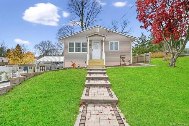 a front view of house with yard and green space