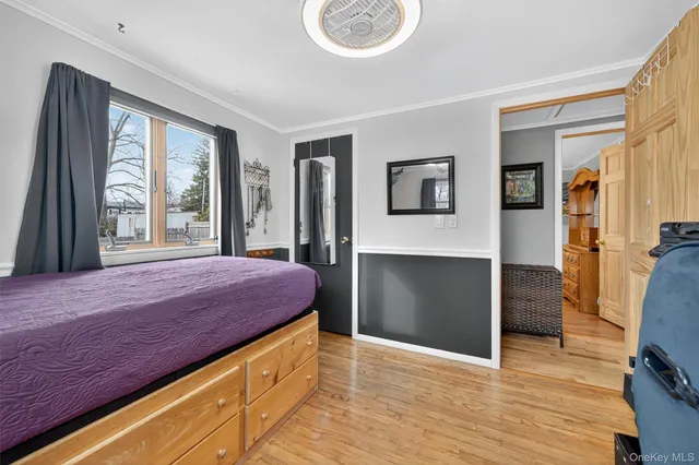 a spacious bedroom with a bed and a large window