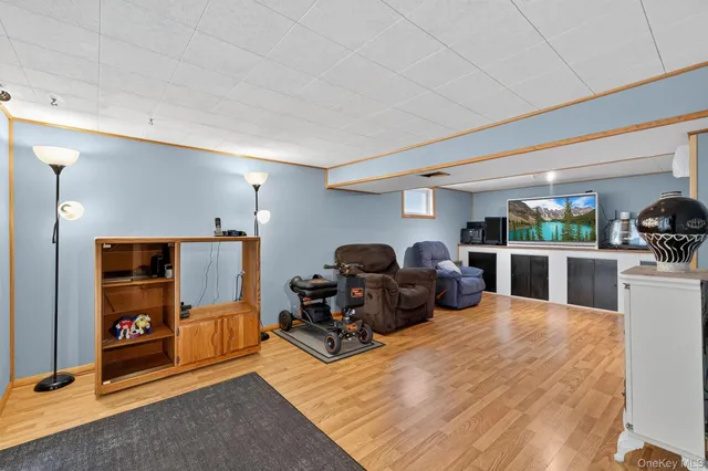 a living room with furniture kitchen view and a large window