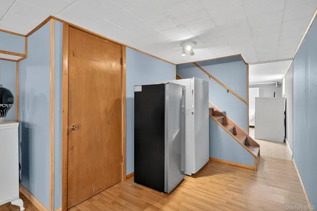 a view of hallway with stairs and wooden floor