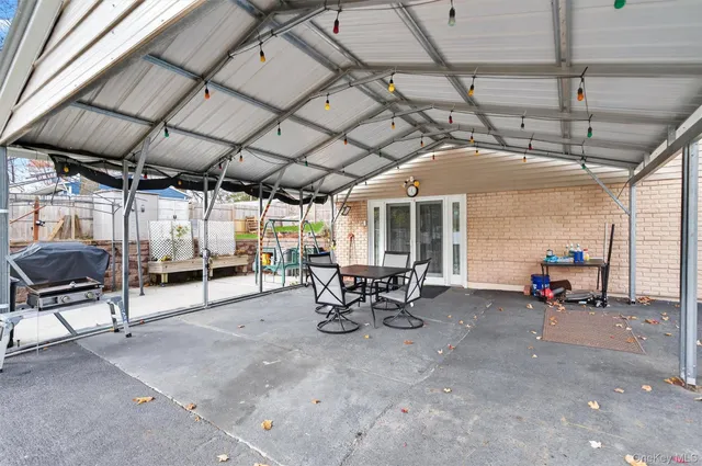 a view of a patio with table and chairs and potted plants
