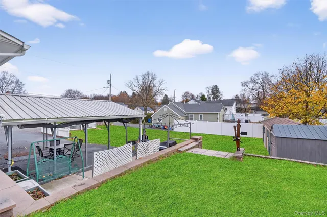 a view of a house with a yard and sitting area