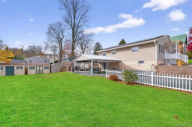 a view of a house with a yard and deck