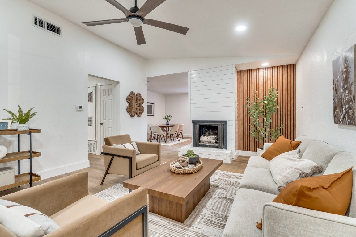 a living room with furniture and a fireplace