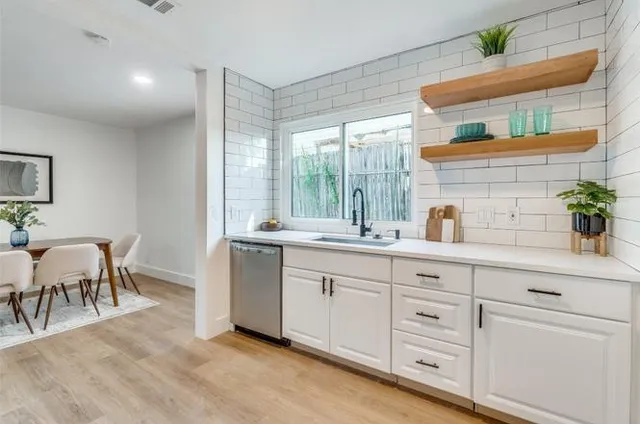 a spacious bathroom with double sink and a large mirror