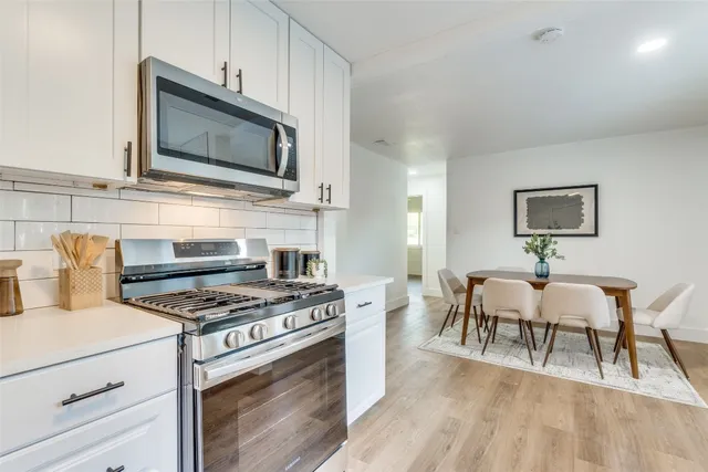 a kitchen with a stove and a microwave area
