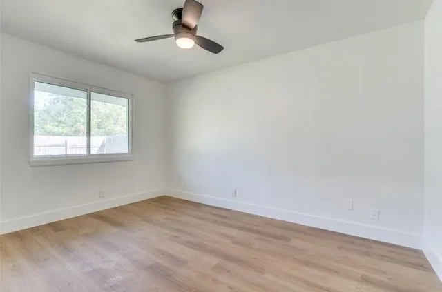 a bathroom with a toilet sink vanity tub and mirror