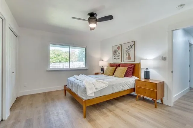 a bedroom with a bed and a chandelier