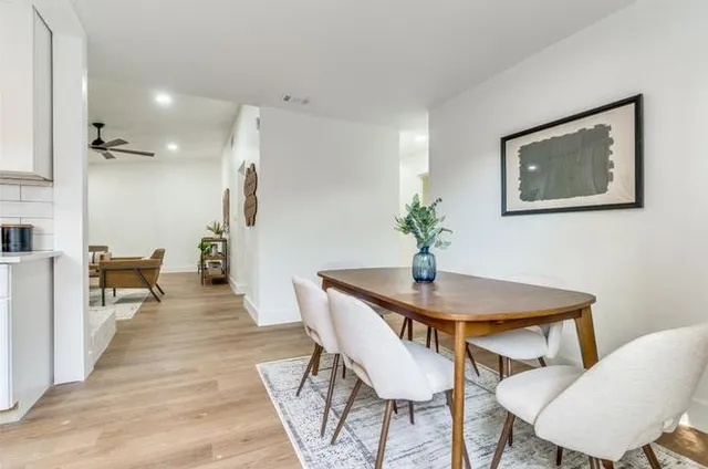 a dining room with furniture and wooden floor