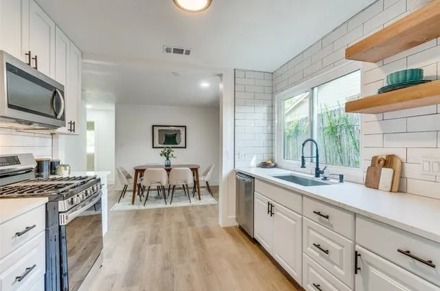 a kitchen with a sink and a stove top oven