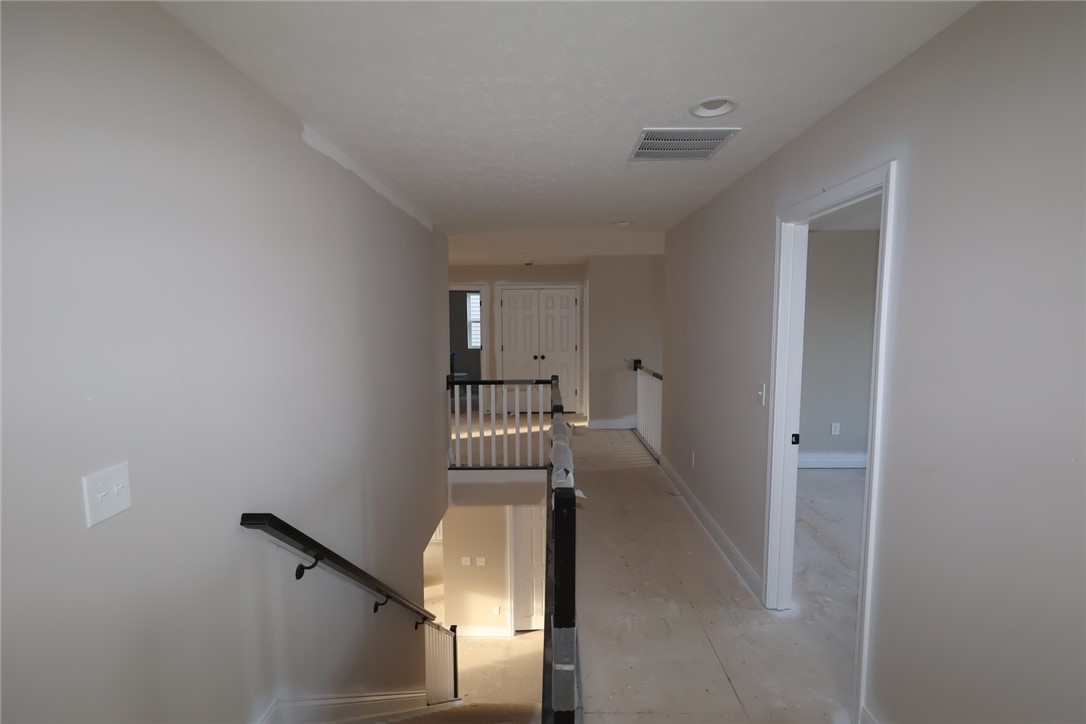 240 Tilly Court, Unit 5 Springboro, OH 45066 - Photo 12 of 26 This spacious hallway features an inviting staircase leading to the upper level.