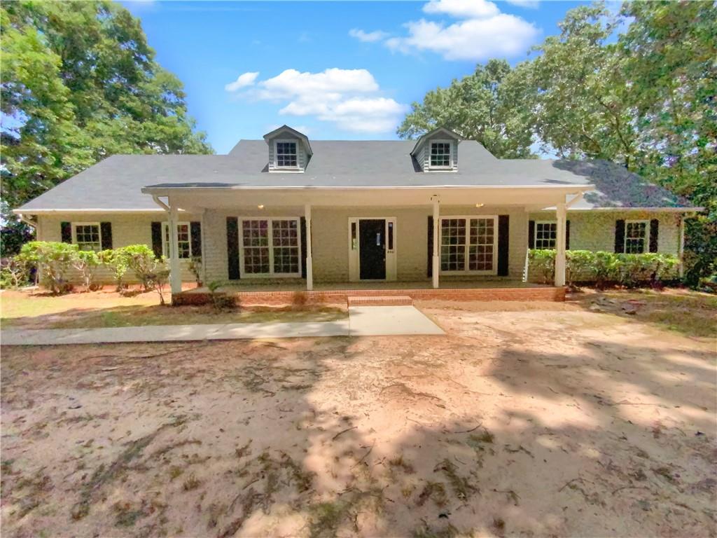 890 Thurman Road Stockbridge, GA 30281 - Photo 1 of 1 a front view of a house with a yard and potted plants