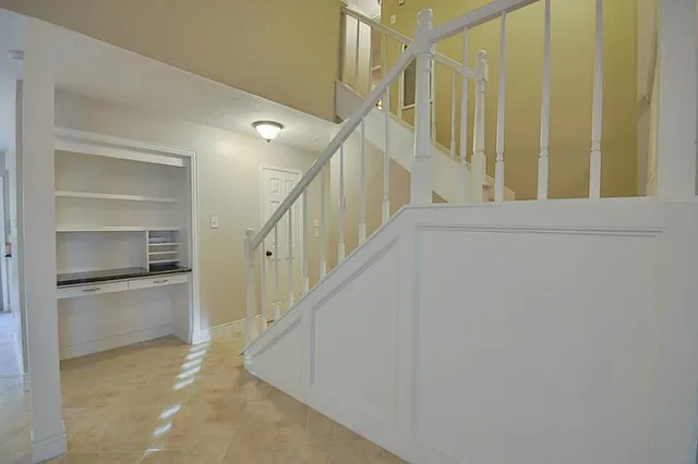 a view of entryway and hall with a front door