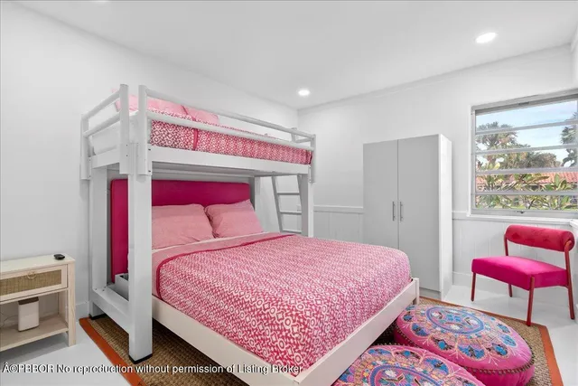 a bedroom with a bed a rug and a window