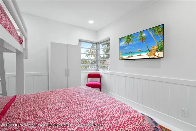 a bedroom with a bed and a view of kitchen