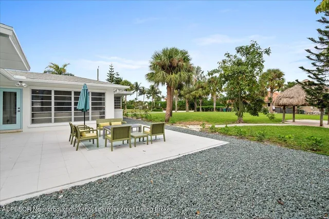a view of a house with garden and sitting area
