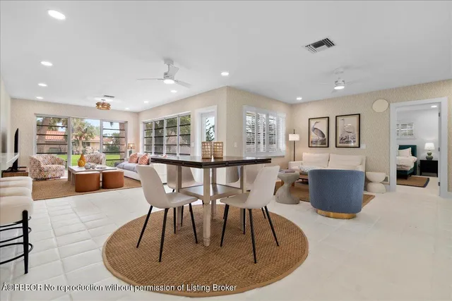 a living room with furniture and a view of kitchen