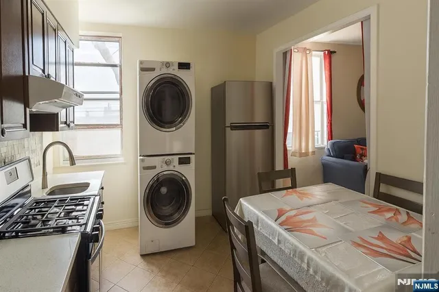 a bedroom with a bed and a washing machine in it