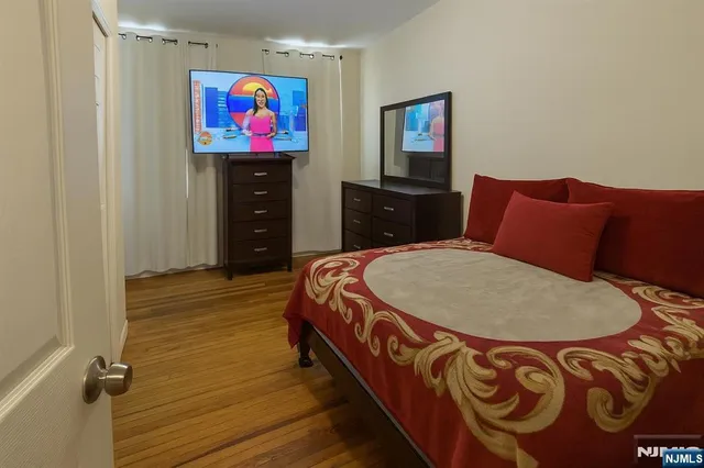 a bed room with a bed and dresser