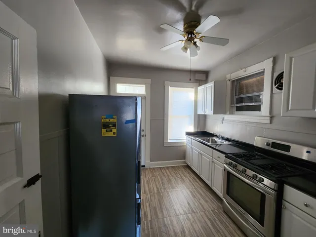a kitchen with stainless steel appliances granite countertop a stove a refrigerator and a sink