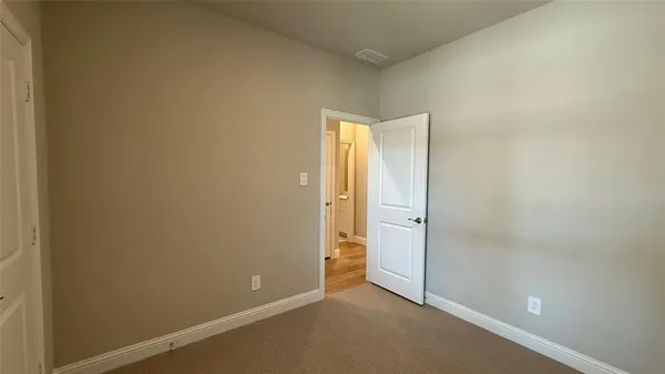 an empty room with closet area