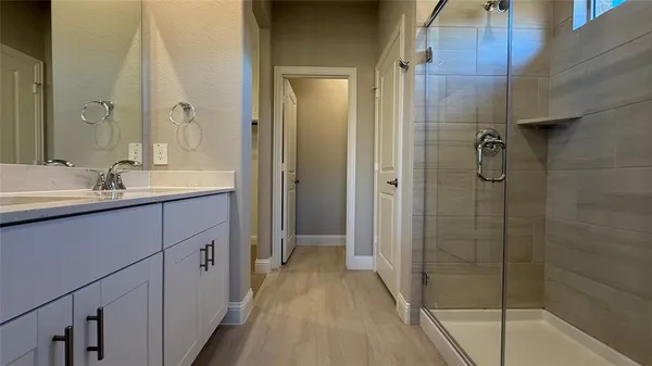 a bathroom with a shower and a sink