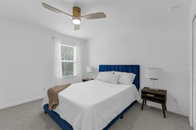 a bedroom with a bed a dresser and a window