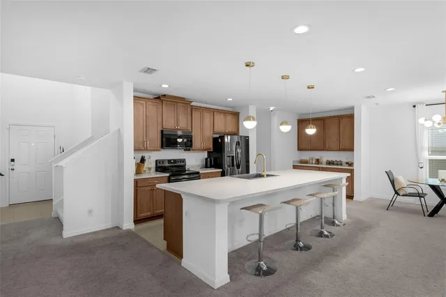 a kitchen with a stove a refrigerator and a refrigerator