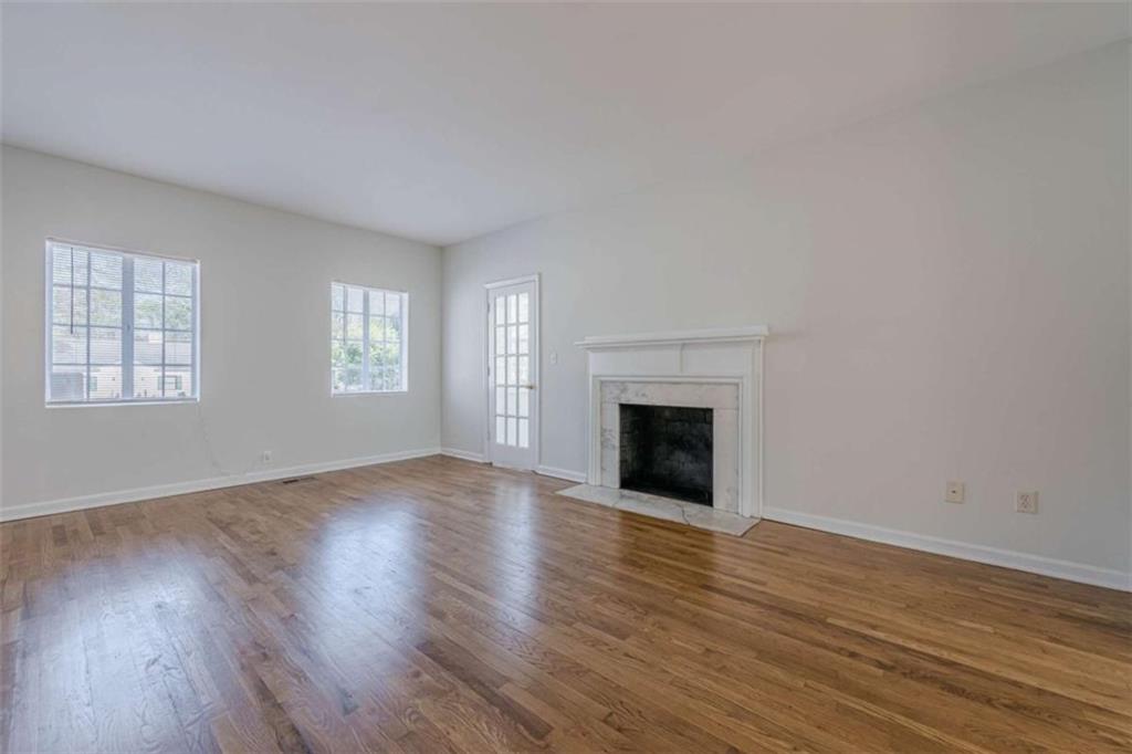 1977 North Decatur Road Atlanta, GA 30307 - Photo 9 of 59 an empty room with wooden floor fireplace and windows