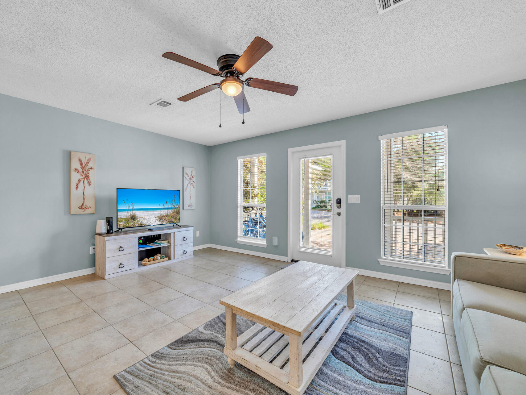 223 Redfish Circle Santa Rosa Beach, FL 32459 - Photo 3 of 26 a living room with furniture a flat screen tv and a ceiling fan