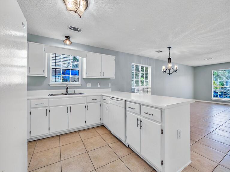 223 Redfish Circle Santa Rosa Beach, FL 32459 - Photo 4 of 26 a kitchen with cabinets appliances a sink and a window