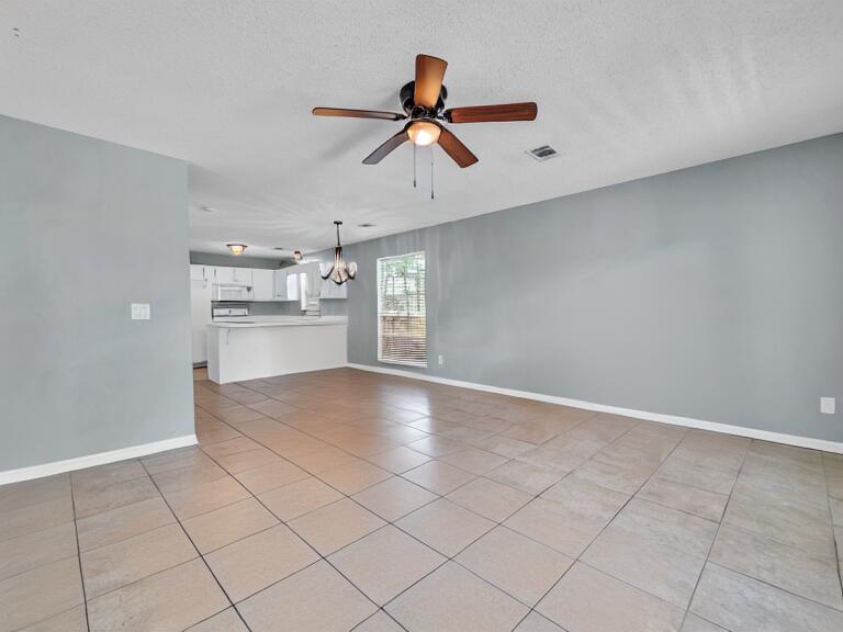 223 Redfish Circle Santa Rosa Beach, FL 32459 - Photo 5 of 26 a view of empty room with wooden floor and window
