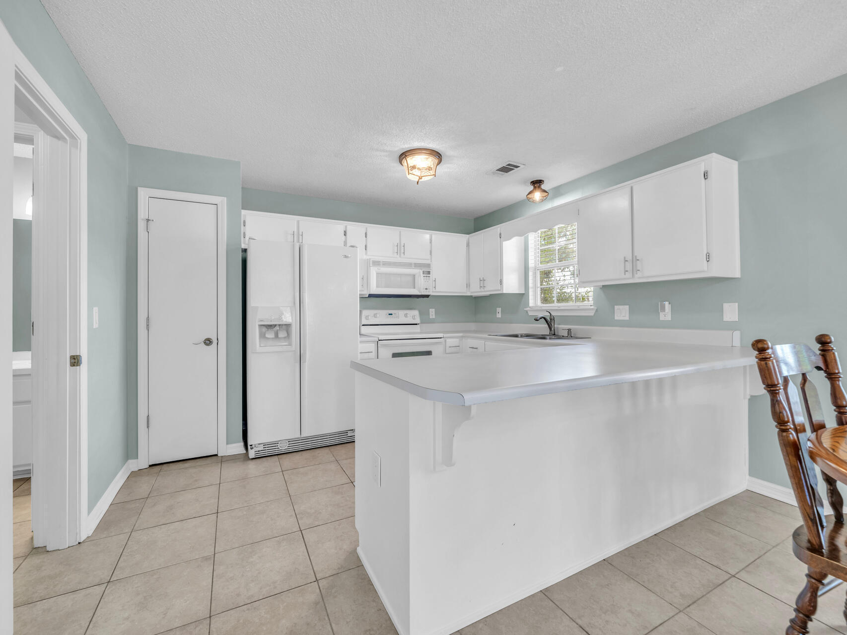 223 Redfish Circle Santa Rosa Beach, FL 32459 - Photo 8 of 26 a kitchen with stainless steel appliances a refrigerator sink and cabinets