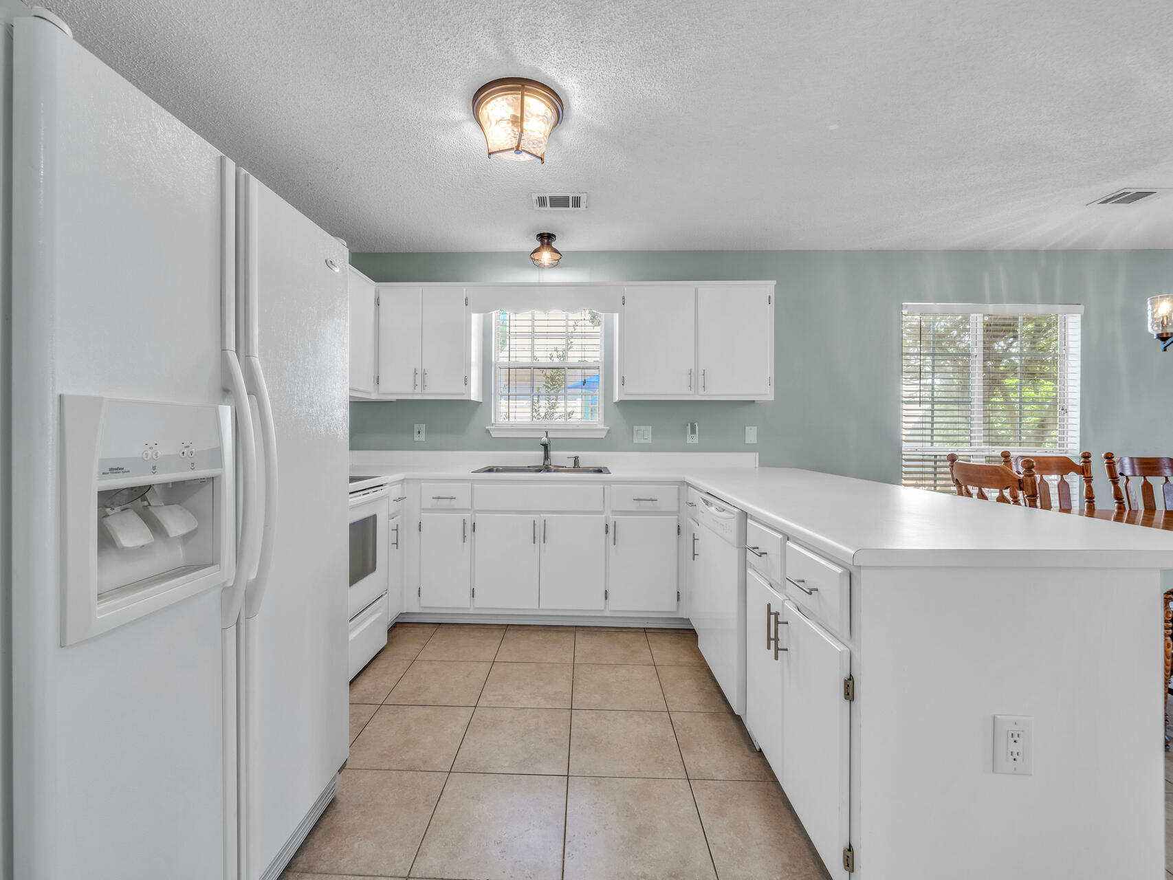 223 Redfish Circle Santa Rosa Beach, FL 32459 - Photo 9 of 26 a kitchen with a white cabinets and window