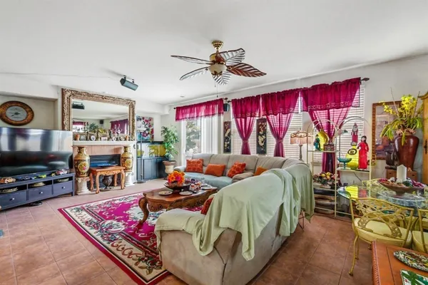 a bedroom with bed and a flat tv screen on dresser