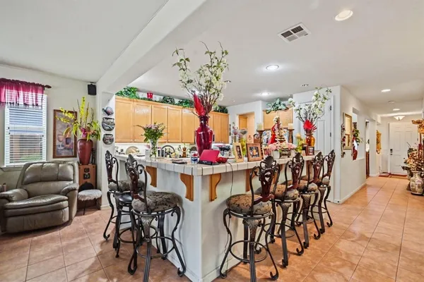 a view of a dining room with furniture and chandelier