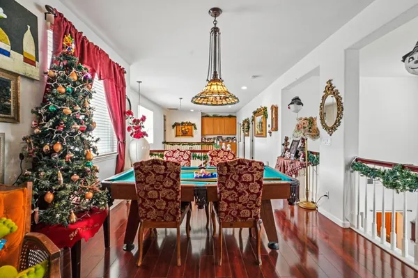 a view of a dining room with furniture and chandelier