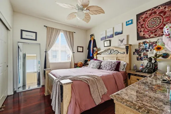 a bedroom with a bed and wooden floor