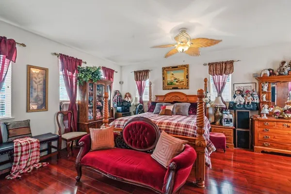a bedroom with furniture and wooden floor