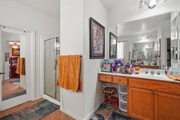a bathroom with a sink mirror and shower
