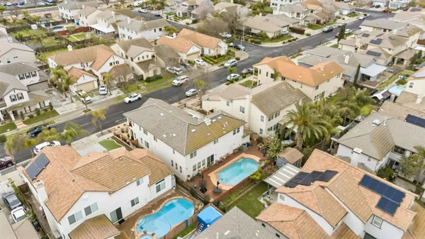 an aerial view of residential houses with outdoor space