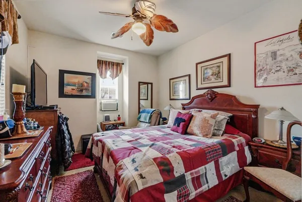 a bedroom with bed and wooden floor